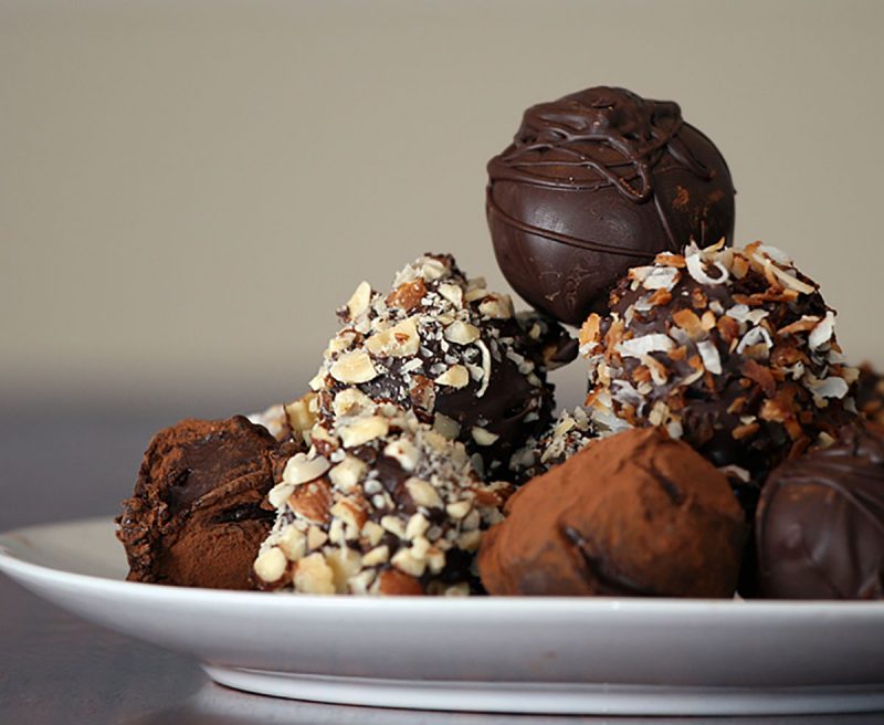 A plate piled high with chocolate truffles of all kinds