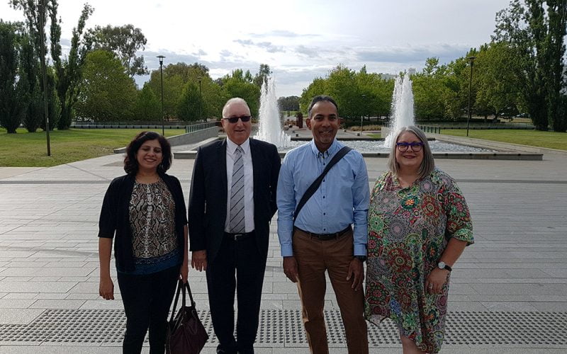 Four delegates outside in front of the fountains. Left to right: Sonali Marathe Royal Institute for Deaf and Blind Children, Tony Starky of Royal Society of the Blind, Dinesh Burah VisAbility team member, and Anthea Taylor Vision Australia.