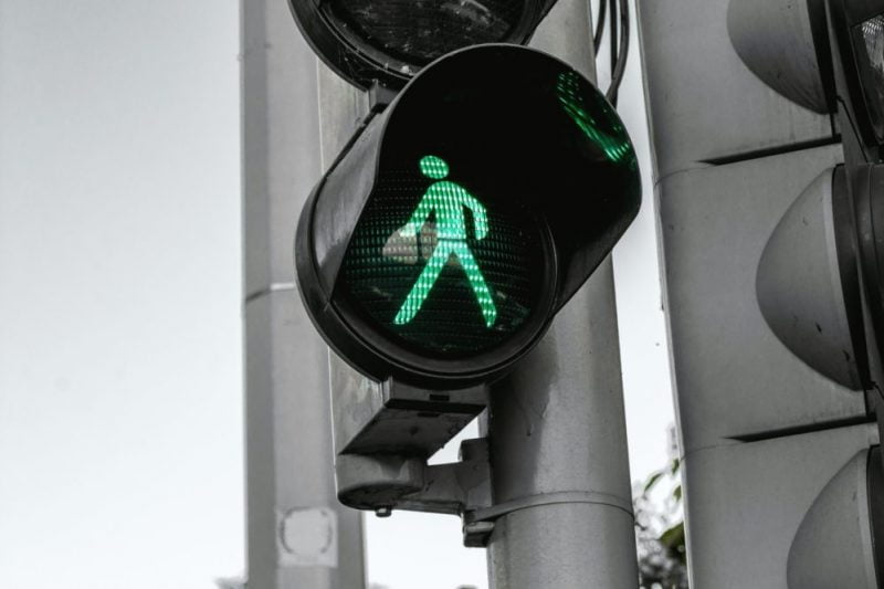 Image shows a traffic light - with the green walking light lit up 