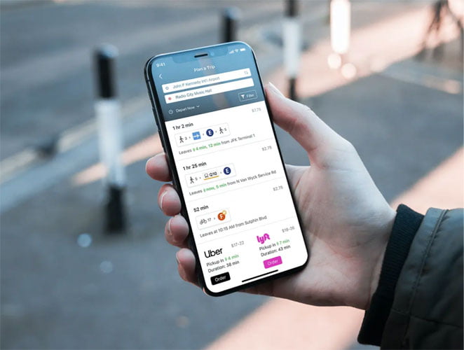 Close up of a phone with Moovit on screen showing directions to get to a music hall
