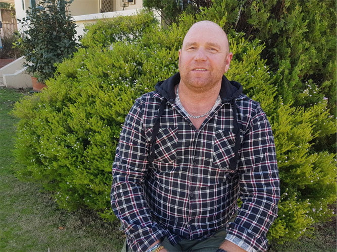 Todd sitting in his garden
