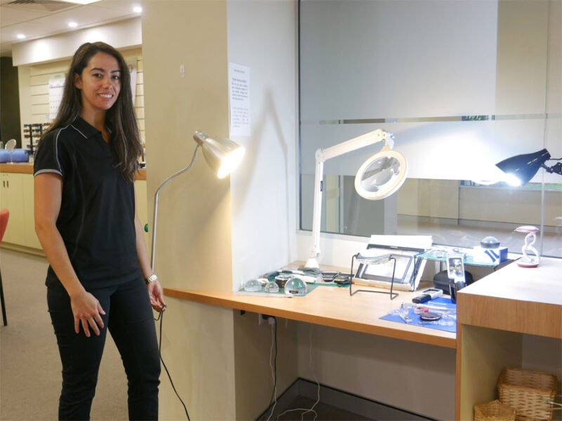 Occupational Therapist Keearny stands by a range of lighting options in the VisAbility shop