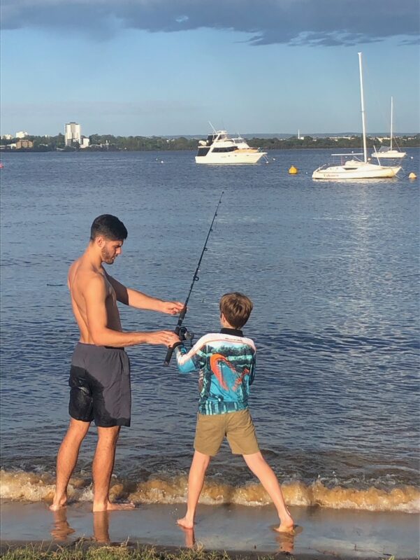 Jackson fishing on teh Swan River with a young lad.