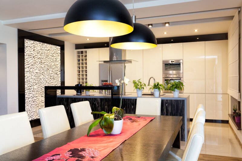 Modern kitchen with plenty of downlighting over dining table