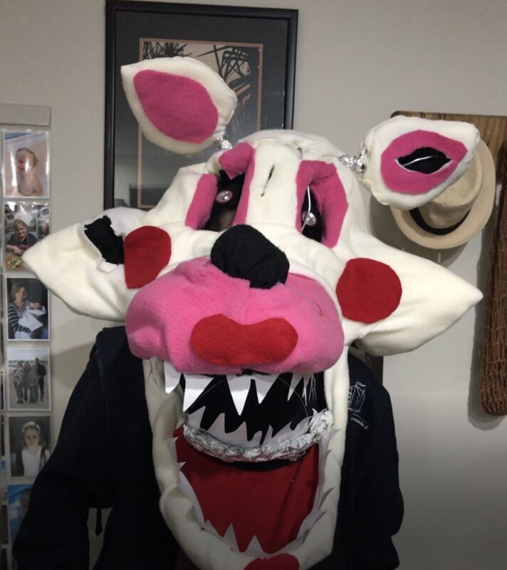 Tayla wearing one of her masks which is pink and white with big felt ears