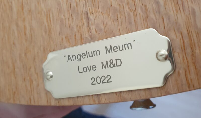 Image shows inscription on the front of the guitar. It reads Angelum Meum - Love M&D 2022
