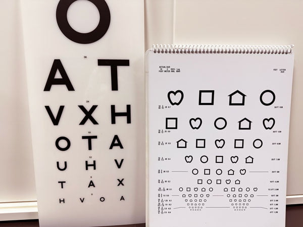 images shows eye charts with traditional large letters and symbols dwindling in size 